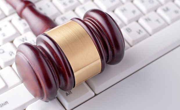 a gavel on top of a keyboard which portrays law firms using social media that is used for basic marketing