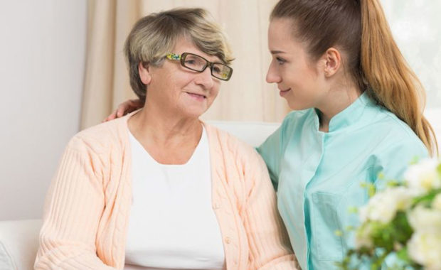 an in-home care agent assisting a senior with daily living activities