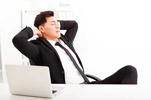 Businessman able to relax after setting up email automation and lead generation through marketing automation