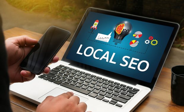 a slideshow describing local SEO on a laptop computer that a digital marketing agency is showing to the owner of a local business