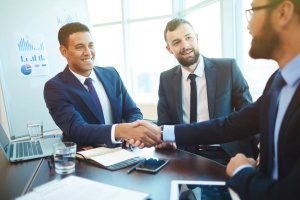 attorney shaking hands with a digital marketing agency to discuss his law firm marketing plan