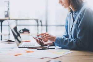 A digital marketing agency employee double checking one of her social media accounts to confirm her client's digital marketing services are still loading properly