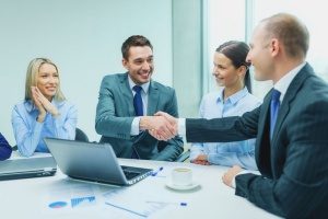 an insurance broker that is shaking hands with the owner of a digital marketing agency to discuss how the brokerage can generate more business leads in the coming months