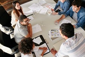 Dental marketing agency sitting around a table developing a content marketing strategy for a client