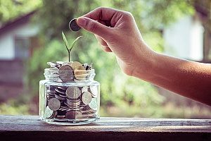 a jar of money that a business was able to save due to the help of a digital marketing agency and their effective marketing strategy