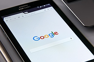 a businessman using Google on his mobile phone to test his Ashburn, VA SEO strategies