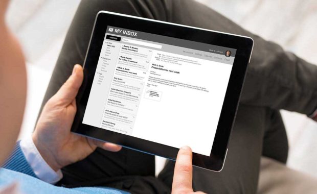 man reviewing his email marketing campaign on a tablet