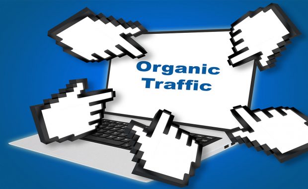 Organic Traffic concept with pointing hand icons pointing at the laptop