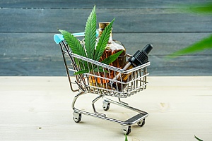 a small shopping cart with cannabis products to represent a dispensary marketing plan