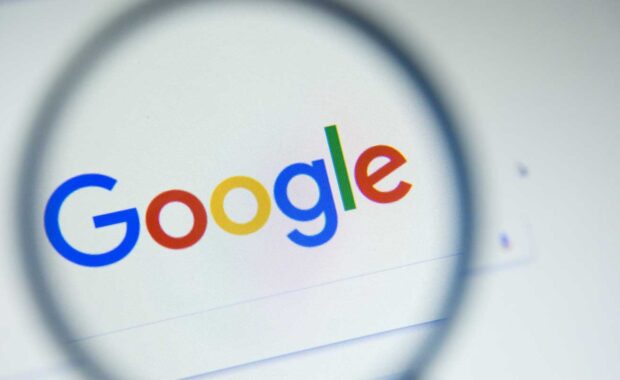Magnifying glass hovering over Google's search ranking systems