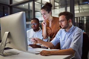 Three employees doing keyword research in the office