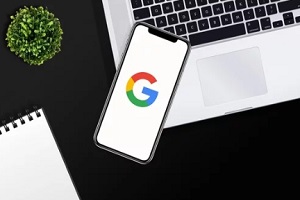 google on mobile with laptop
