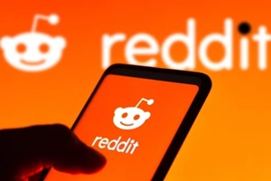 photo illustration the Reddit logo seen displayed on a smartphone and on the background