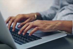 women hands typing on macbook