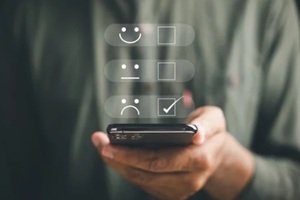 person holding smartphone showing one star rating